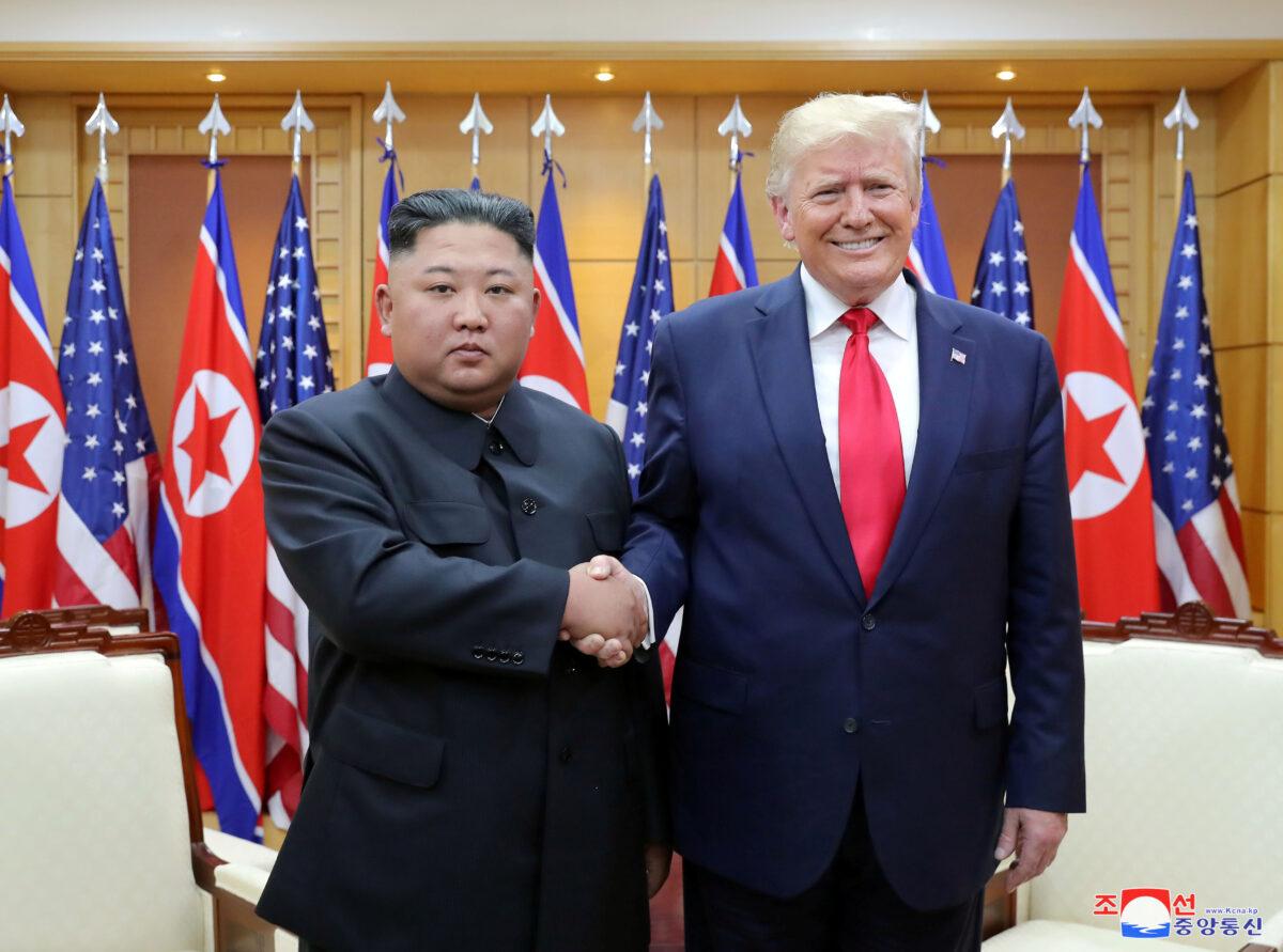 President Donald Trump shakes hands with North Korean leader Kim Jong Un as they meet at the demilitarized zone separating the two Koreas, in Panmunjom, South Korea on June 30, 2019. (KCNA via Reuters)