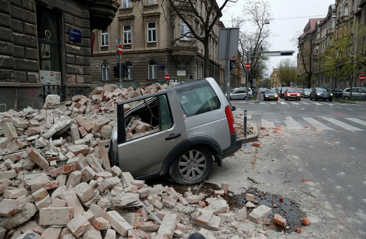 A car is crushed by falling debris after an earthquake in Zagreb, Croatia, on March 22, 2020. (Darko Bandic/AP Photo)