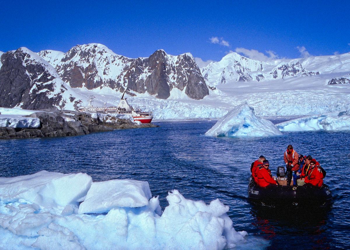 Tourists get from ship to landing and back aboard a small rubber vessel called a Zodiac. (Copyright Fred J. Eckert)