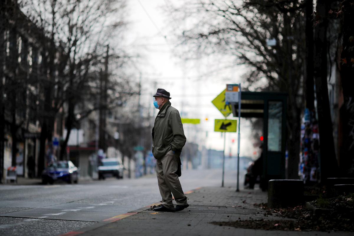 A man waits for a bus amid the COVID-19 outbreak in Seattle, Washington, on March 22, 2020. (Reuters/Brian Snyder)