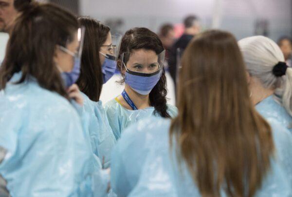Medical staff prepare for the opening of the COVID-19 Assessment Centre at Brewer Park Arena in Ottawa, Canada, on March 13, 2020. (Justin Tang/The Canadian Press)