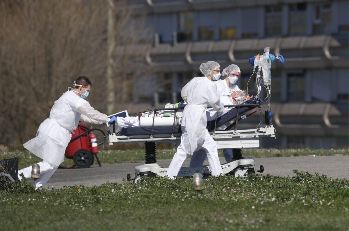A victim of the COVID-19 virus is evacuated from the Mulhouse civil hospital, eastern France on March 23, 2020. (Jean-Francois Badias/AP Photo)