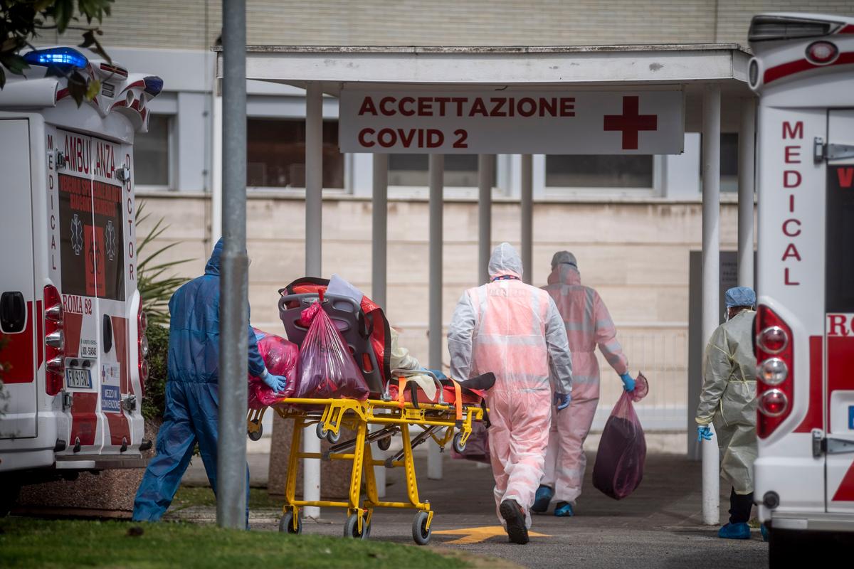 Medical staff collect a patient from an ambulance at the Columbus Covid 2 Hospital in Rome on March 17, 2020. (©Getty Images | <a href="https://www.gettyimages.com/detail/news-photo/medical-staff-collect-a-patient-from-an-ambulance-at-the-news-photo/1207460839?adppopup=true">Antonio Masiello</a>)