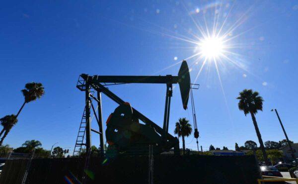 A pumpjack from California-based energy company Signal Hill Petroleum is seen in front of the landmark Curley's Cafe in Signal Hill, Calif., on Oct. 21, 2019. (Frederic J. Brown/AFP via Getty Images)