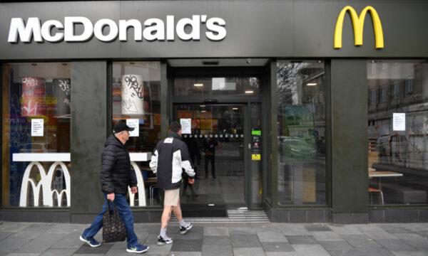 Two people make their way into a McDonalds restaurant that will only be offering takeaways due to the CCP virus in Plymouth, UK, on March 19, 2020. (Dan Mullan/Getty Images)