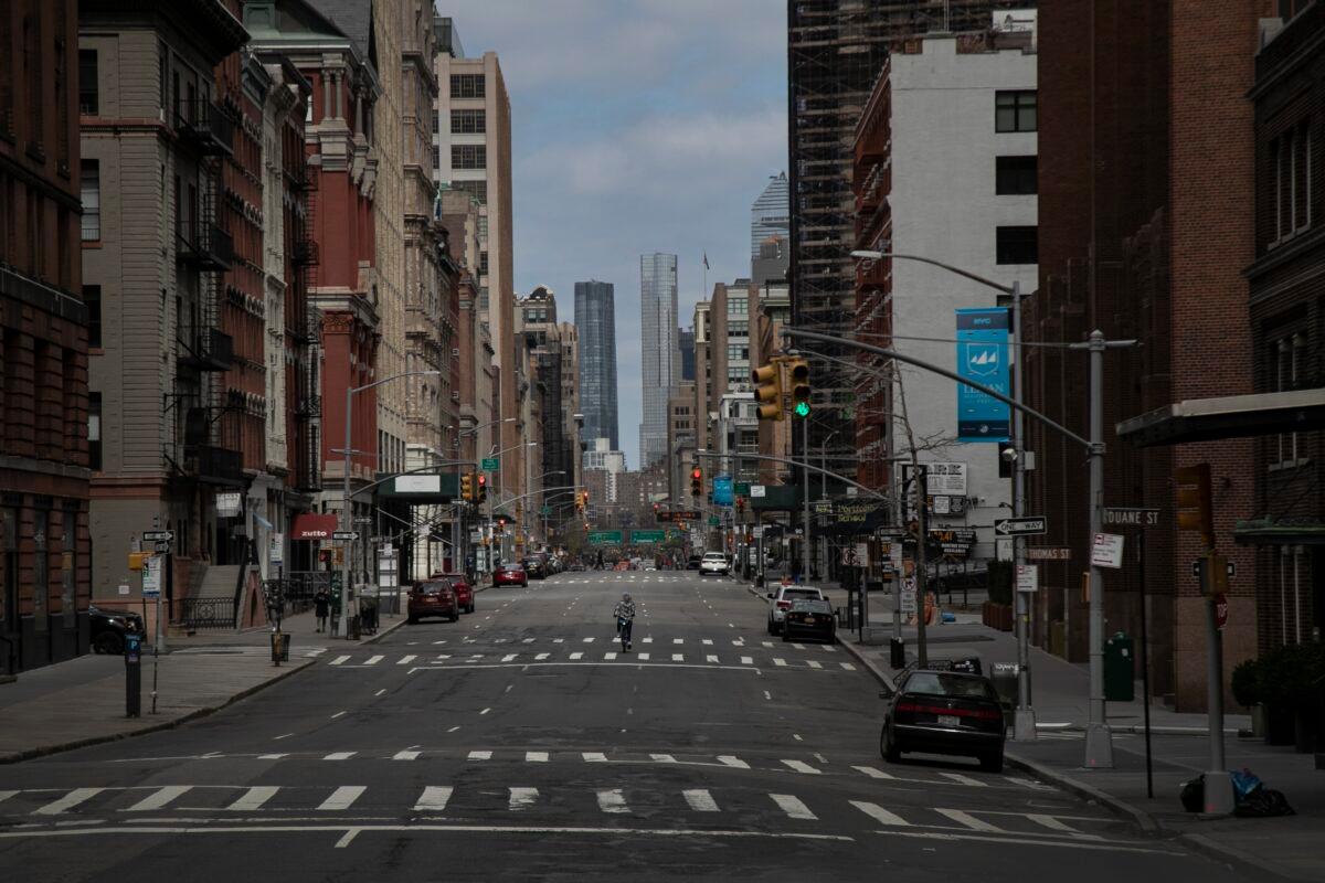 A cyclist rides his bicycle down the middle of a main road in downtown New York City on March 22, 2020. (Wong Maye-E/AP Photo)