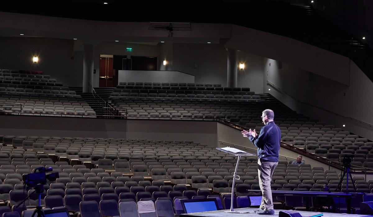 Senior Pastor Troy Dobbs speaks to empty pews after Grace Church Eden Prairie decided to present worship music and the sermon to an estimated 3,500 online viewers in Eden Prairie, Minnesota on March 15, 2020. Adam Bettcher/Getty Images)