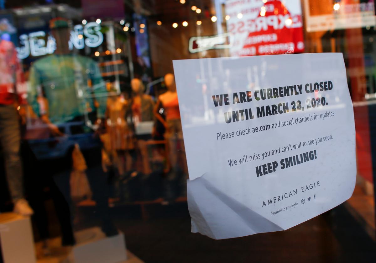 A sign is displayed showing information about store times at a store in Times Square in New York City on March 22, 2020. (Keta Betancur/AFP via Getty Images)