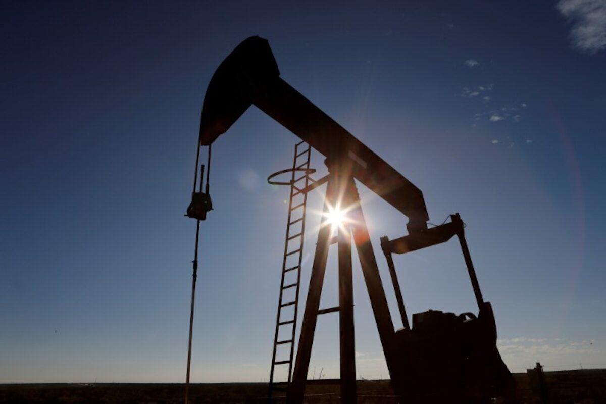 The sun is seen behind a crude oil pump jack in the Permian Basin in Loving County, Texas, on Nov. 22, 2019. (Angus Mordant/Reuters)