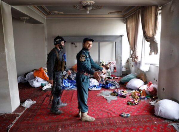 Afghan policemen inspect the Sikh religious complex after an attack in Kabul, Afghanistan, on March 25, 2020. (Mohammad Ismail/Reuters)