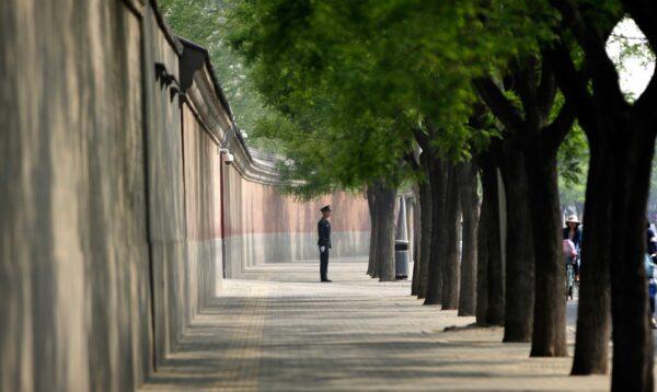 A soldier keeps watch next to a red wall outside the Zhongnanhai leadership compound in Beijing on May 6, 2013. (Jason Lee/AFP via Getty Images)