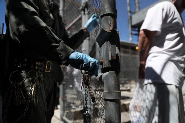 A California Department of Corrections and Rehabilitation officer opens the gate for a condemned inmate who is leaving the exercise yard at San Quentin State Prison's death row in San Quentin, Calif., on Aug. 15, 2016. (Justin Sullivan/Getty Images)