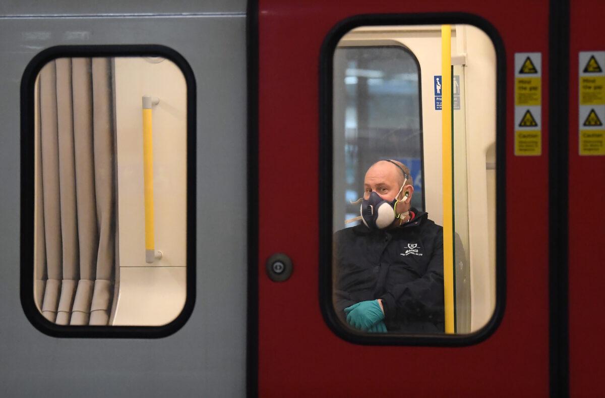 A member of the public wears a a protective mask on the Tube in London on March 25, 2020. (Alex Davidson/Getty Images)