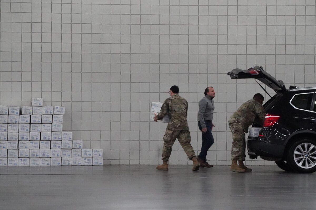 U.S. Army National Guard members unload boxes at the Jacob Javits Center on Manhattan’s West Side after New York Governor Andrew Cuomo announced that he is converting the center into a field hospital, in New York on March 23, 2020. (Bryan R. Smith/AFP/Getty Images)