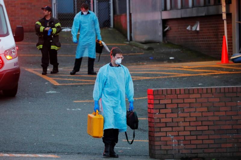 Firefighters wearing personal protective equipment (PPE) walk away after responding to a medical call amid the COVID-19 outbreak in Seattle, Washington, on March 24, 2020. (Reuters/Brian Snyder)