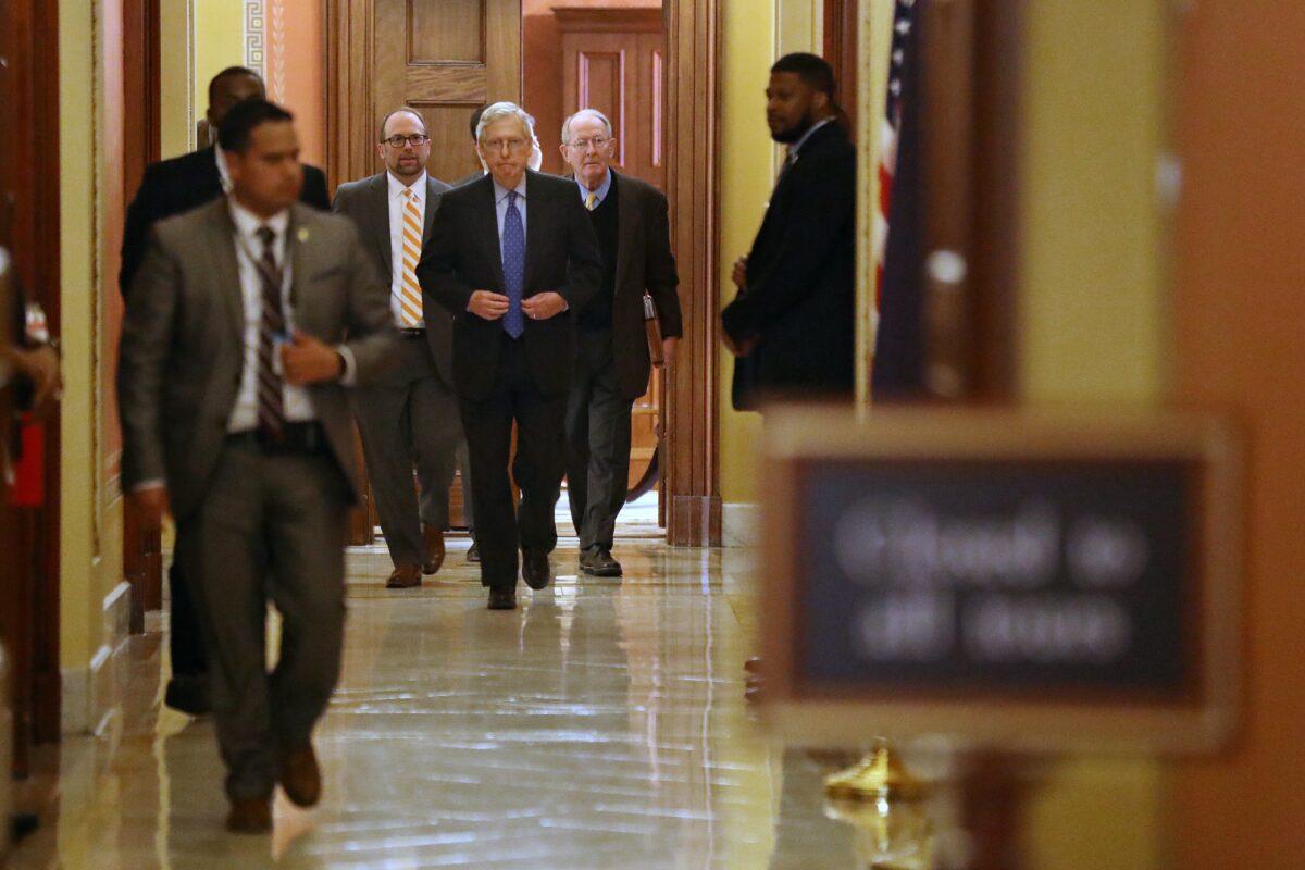 Senate Majority Leader Mitch McConnell (R-Ky.), center, leaves a meeting in Washington on March 24, 2020. (Chip Somodevilla/Getty Images)