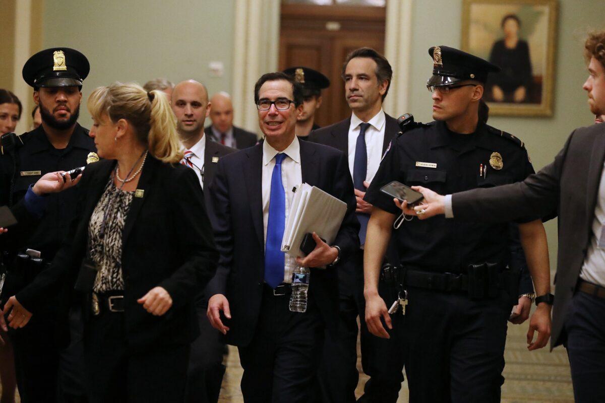 Treasury Secretary Steven Mnuchin (C) leaves the offices of Minority Leader Charles Schumer (D-N.Y.) as negotiations continued into the night on a $2 trillion economic stimulus in response to the coronavirus pandemic at the U.S. Capitol on March 24, 2020. (Chip Somodevilla/Getty Images)