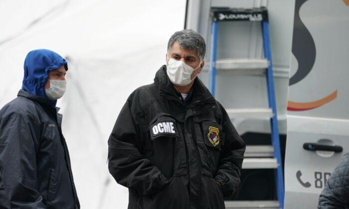 A member of the NYC Medical Examiner's Office at the site as workers build a makeshift morgue outside of Bellevue Hospital to handle an expected surge in CCP virus victims in New York City on March 25, 2020. (Bryan R. Smith/AFP via Getty Images)