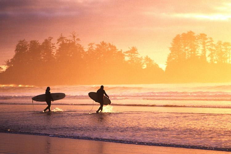 Surfers on Chesterman Beach at sunset. (Adrian Dorst for The Wickaninnish Inn)