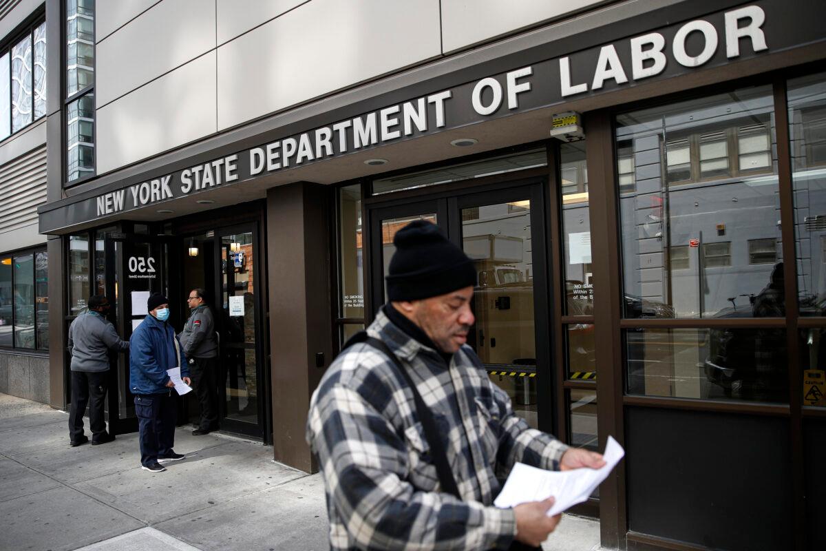 Visitors to the New York State Department of Labor are turned away at the door by personnel, due to closures over CCP virus concerns in New York City, on March 18, 2020. (John Minchillo/AP Photo)