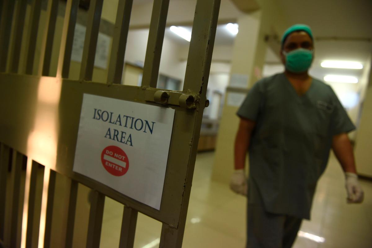 A medical staff member in an isolation ward at the Jinnah Post Graduate Medical Center in Karachi, Pakistan, on Feb. 3, 2020 (©Getty Images | <a href="https://www.gettyimages.com/detail/news-photo/medical-staff-member-wearing-protective-facemask-walks-in-news-photo/1198367590?adppopup=true">RIZWAN TABASSUM</a>)