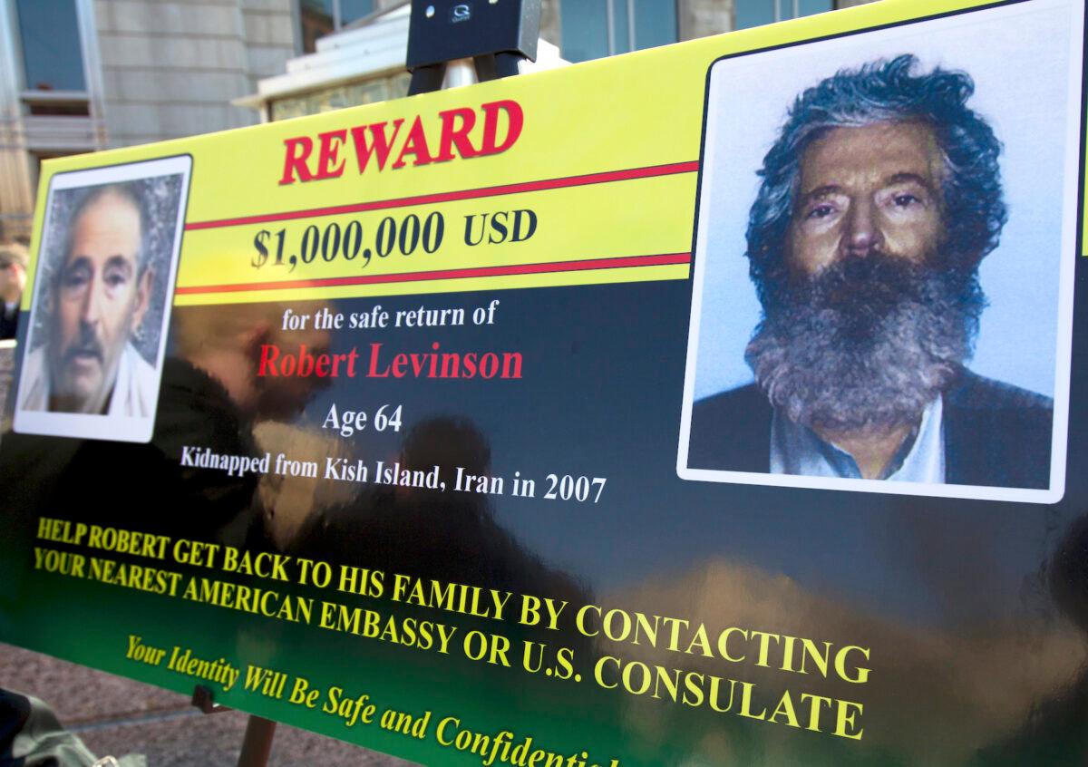 An FBI poster showing a composite image of former FBI agent Robert Levinson, right, of how he would look like now, left, (taken from the video released by his captors) in Washington during a news conference on March 6, 2012. (Manuel Balce Ceneta/AP Photo)