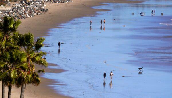 People walks along Zuma Beach, in Malibu, Calif., on March 23, 2020. (Mark J. Terrill/AP Photo)