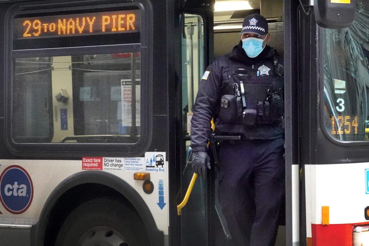 A police officer steps off a bus in the Loop business district during rush hour in Chicago, Illinois on March 20, 2020. (Scott Olson/Getty Images)