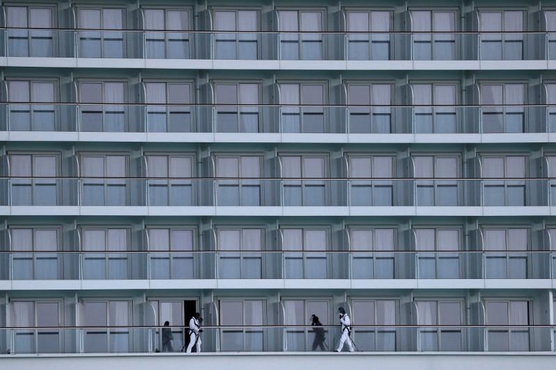 Members of a cleaning crew are seen while working on a cruse ship at Port of Miami after the Florida Department of Health reported more than 2300 confirmed cases of CCP virus in Miami, Florida on March 26, 2020. (Carlos Barria/Reuters)