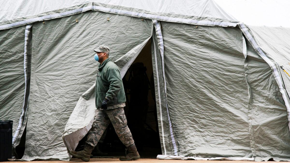 An Air Force member exits a tent erected as a makeshift morgue outside of Bellevue Hospital in New York City on March 25, 2020. (Eduardo Munoz Alvarez/Getty Images)