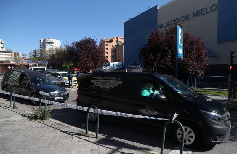 Hearses carrying corpses leave an ice rink, being used as a morgue, during the CCP virus outbreak in Madrid on March 26, 2020. (Susana Vera/Reuters)