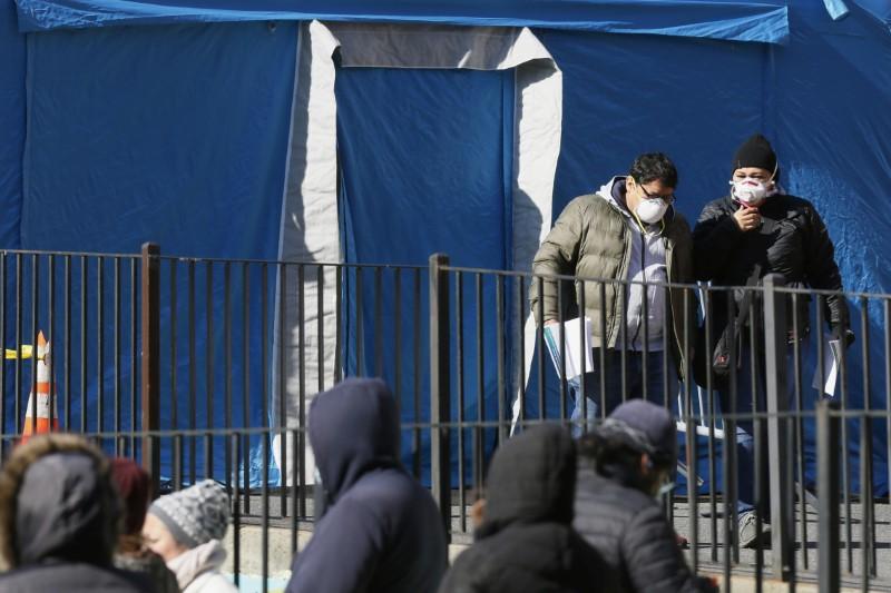 Two people depart a tent after being tested for the CCP virus outside Elmhurst Hospital Center in the Queens borough of New York City on March 26, 2020. (Stefan Jeremiah/Reuters)