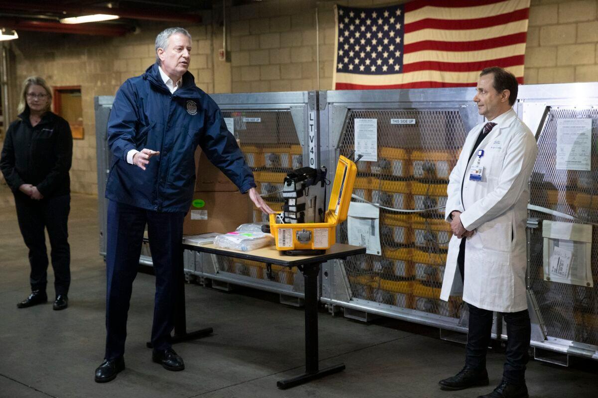 New York City Mayor Bill de Blasio, left, discusses the arrival of a shipment of 400 ventilators with Dr. Steven Pulitzer, the Chief Medical Officer of NYC Health and Hospitals, at the city's Emergency Management Warehouse in New York City on March 24, 2020. (Mark Lennihan/AP Photo)