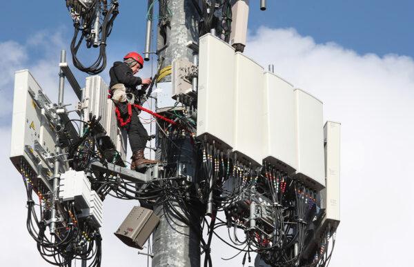 A worker rebuilds a cellular tower with 5G equipment for the Verizon network in Orem, Utah, on Nov. 26, 2019. The new 5G networks that are coming soon, will be 10x faster than the old 4G networks. (George Frey/Getty Images)
