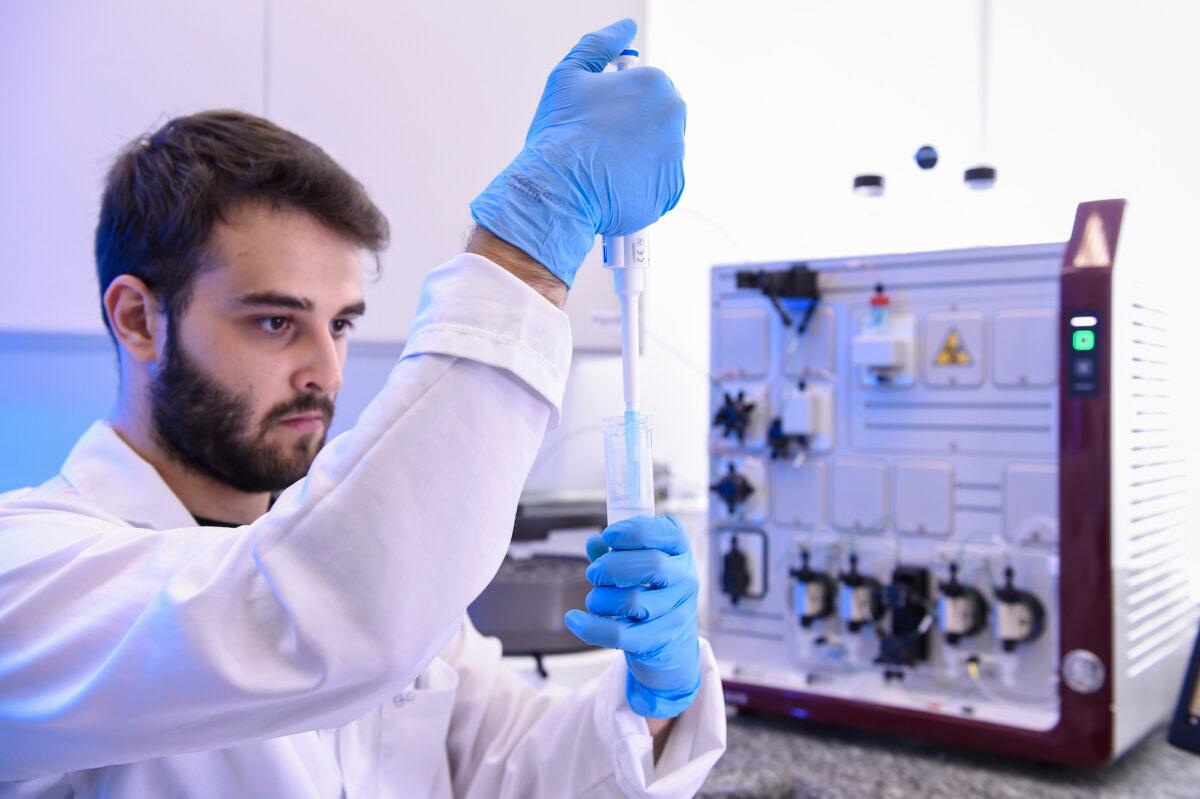 An engineering student works to separate proteins for vaccine production in Belo Horizonte, Brazil, on March 24, 2020. (Pedro Vilela/Getty Images)