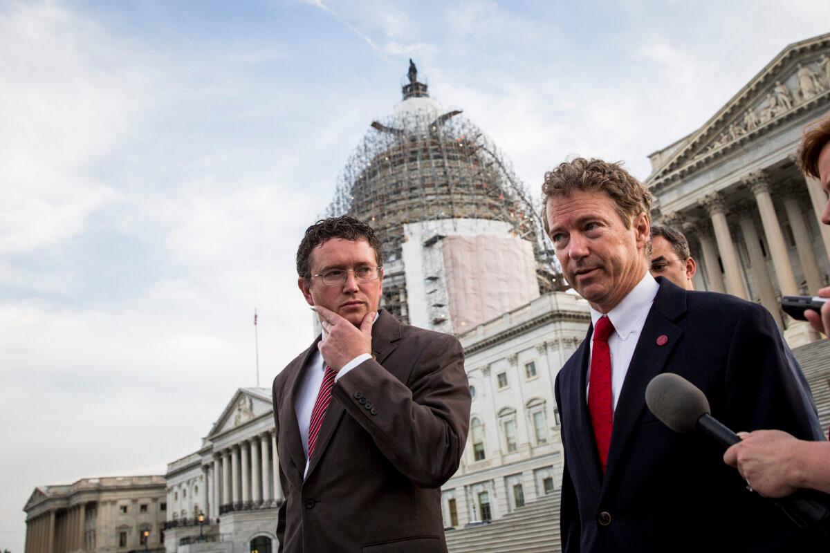 Rep. Thomas Massie (R-KY) listens as Sen. Rand Paul (R-KY) speaks to reporters on Capitol Hill, in Washington, on May 31, 2015. (Drew Angerer/Getty Images)