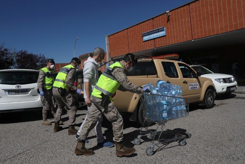 Members of the Spanish army bring water bottles to Severo Ochoa Hospital during the COVID-19 outbreak in Leganes, Spain on March 26, 2020. (Susana Vera/Reuters)
