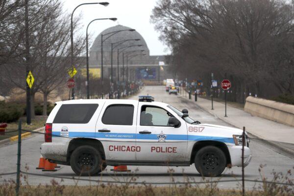 A Chicago police officer blocks the road to the Adler Planetarium along Lake Michigan, on March 26, 2020, in Chicago. (Charles Rex Arbogast/AP Photo)