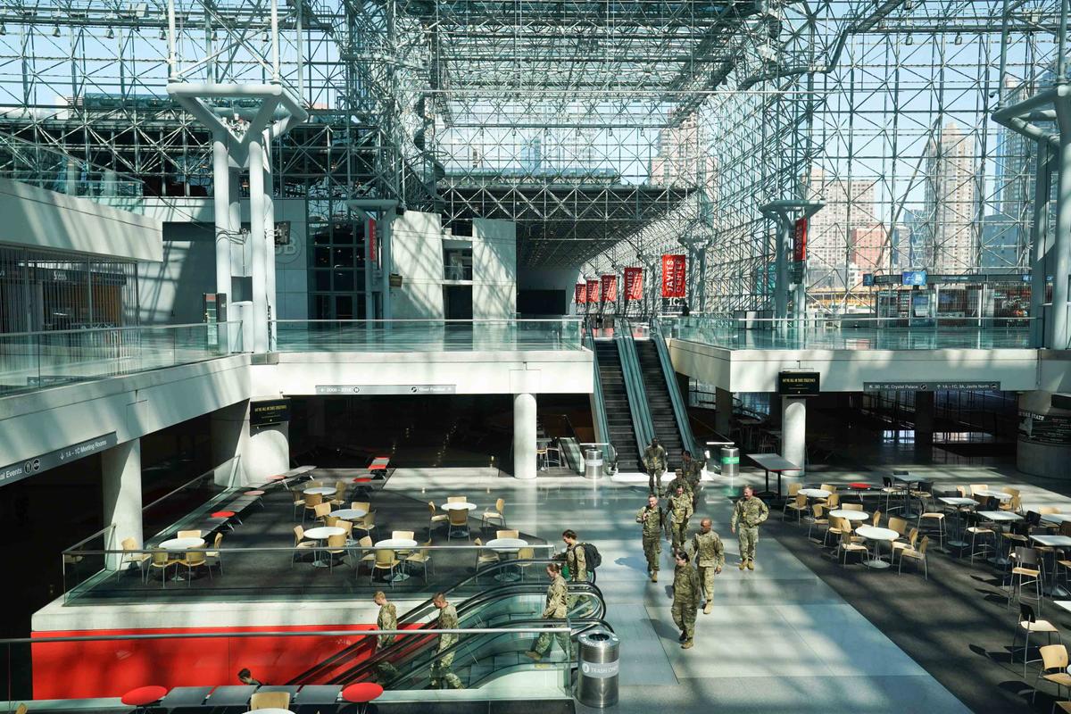 Members of the Army National Guard walk through the Jacob K. Javits Center on March 27, 2020, in New York. (©Getty Images | <a href="https://www.gettyimages.ca/detail/news-photo/members-of-the-army-national-guard-walk-through-the-jacob-k-news-photo/1208429135?adppopup=true">BRYAN R. SMITH/AFP</a>)