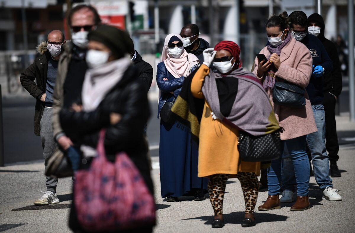 People queue outside the Institut Hospitalo-Universitaire Mediterranee Infection, in Marseille, southeastern France, to be screened for COVID-19, on March 28, 2020. (Anne-Christine Poujoulat/AFP via Getty Images)