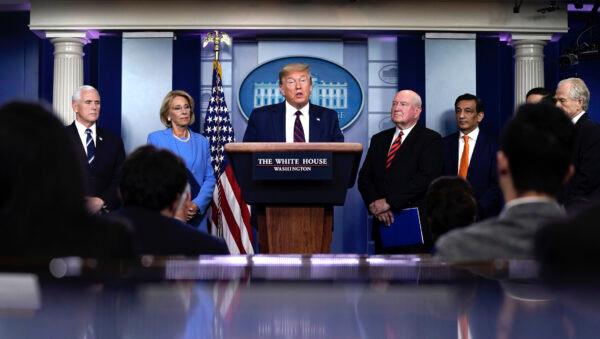 President Donald Trump speaks as Vice President Mike Pence, Secretary of Education Betsy DeVos, and Secretary of Agriculture Sonny Perdue look on during a briefing on the coronavirus pandemic in the press briefing room of the White House, on March 27, 2020. (Drew Angerer/Getty Images)
