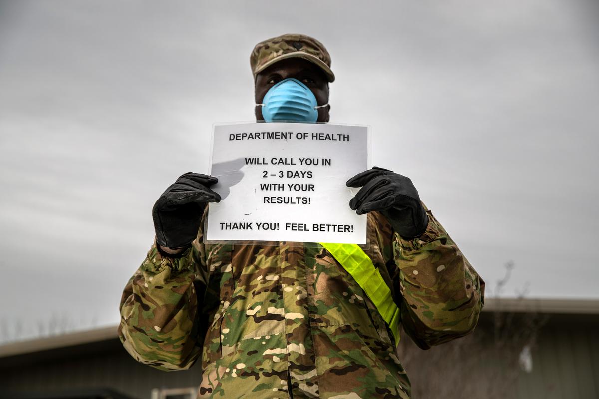 A U.S. National Guard soldier informs patients at a coronavirus testing center at Lehman College on March 28, 2020, in the Bronx, New York City. (©Getty Images | <a href="https://www.gettyimages.com/detail/news-photo/national-guard-soldier-informs-patients-at-a-coronavirus-news-photo/1215355429?adppopup=true">John Moore</a>)