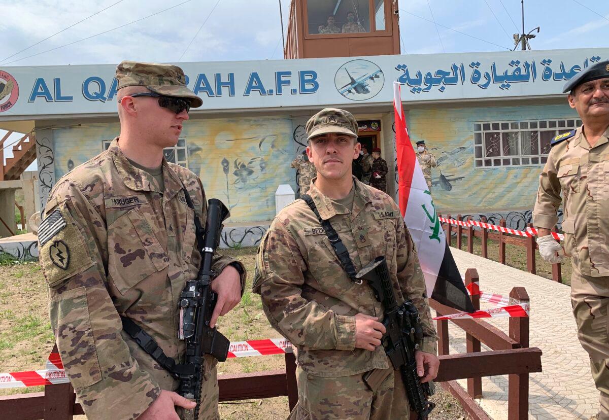 U.S. soldiers stand guard during the handover ceremony of Qayyarah Airfield to Iraqi Security Forces, in the south of Mosul, Iraq, early on March 27, 2020. (Ali Abdul Hassan/AP Photo)
