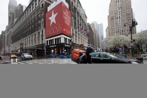 A cyclist passes Macy's in Herald Square in New York onMarch 23, 2020. (AP Photo/Mark Lennihan)