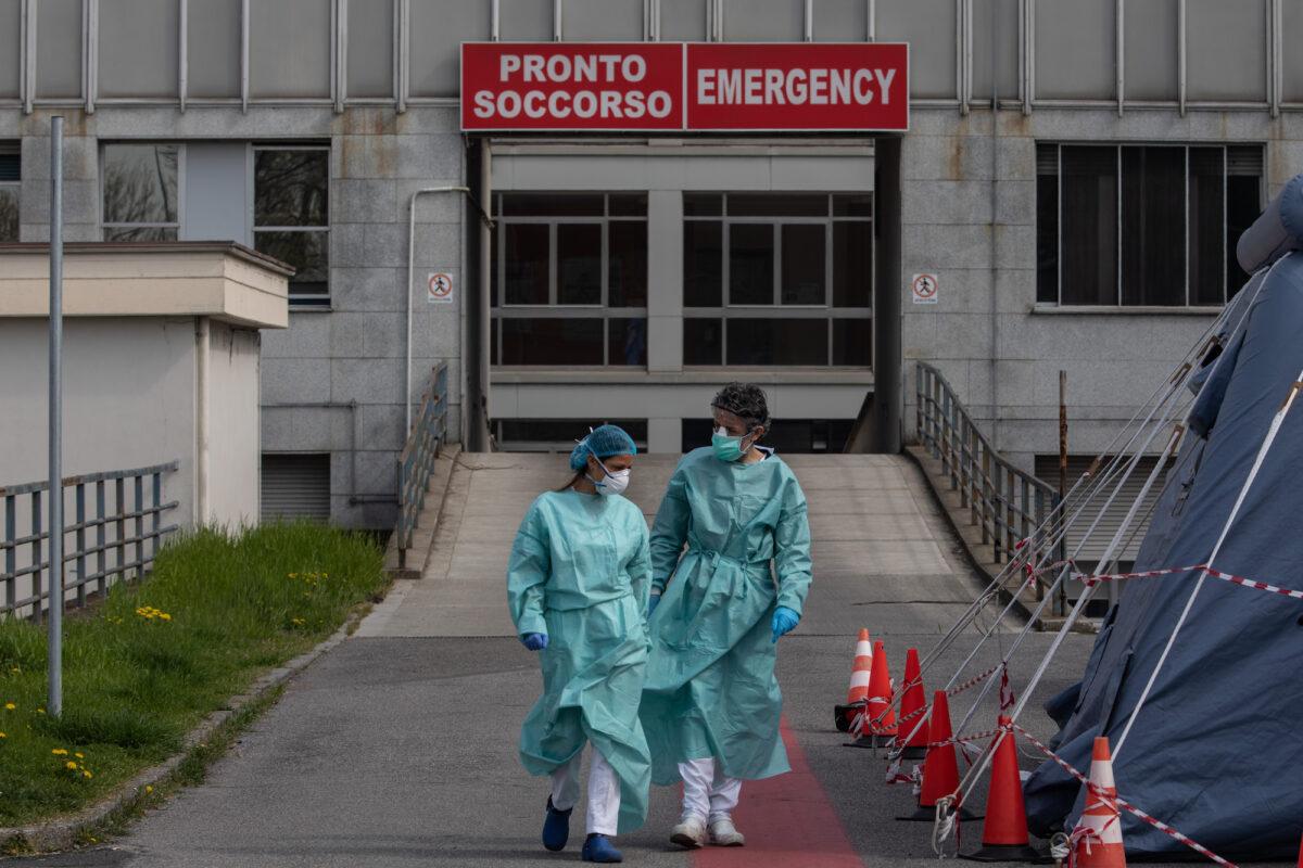 Two nurses walk in front of the Emergency Room of the local hospital in Cremona, near Milan, Italy, on March 20, 2020. (Emanuele Cremaschi/Getty Images)