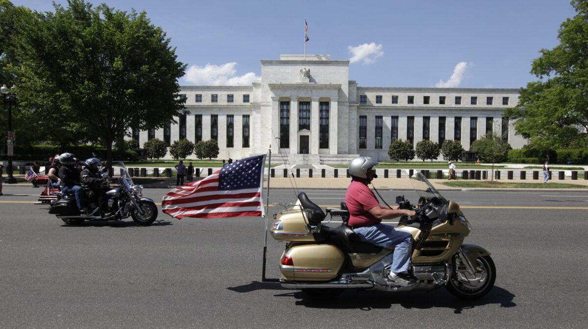 A motorcyclist rides by the Federal Reserve building in Washington, on May 24, 2015. (Chris Kleponis/AFP/Getty Images)