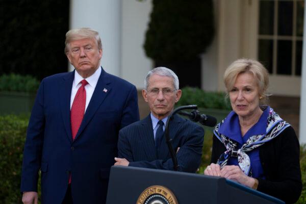 President Donald Trump and Dr. Anthony Fauci, director of the National Institute of Allergy and Infectious Diseases, listen to White House coronavirus response coordinator Dr. Deborah Birx speak in the Rose Garden at the White House in Washington on March 29, 2020. (Tasos Katopodis/Getty Images)