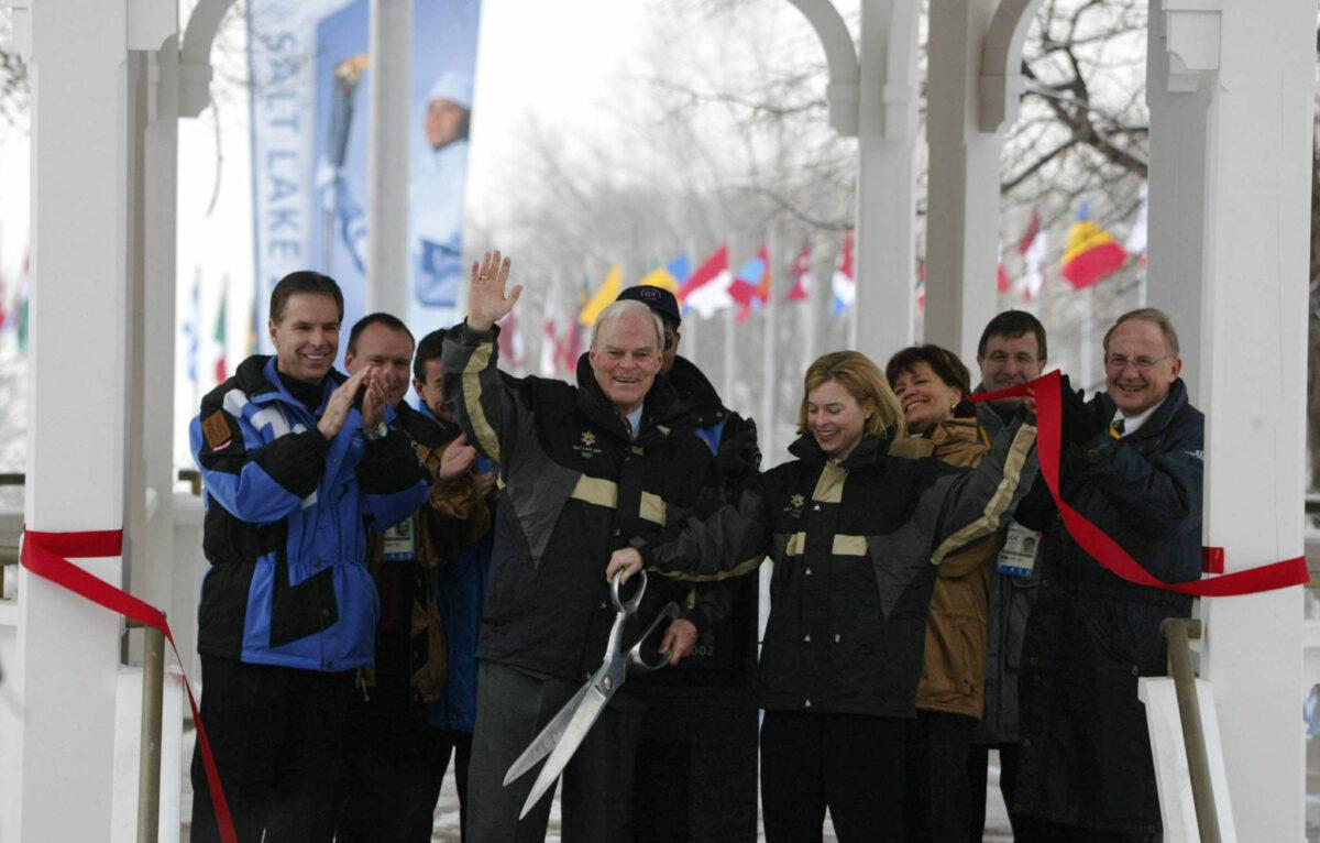 Members of the Salt Lake Organizing Committee (SLOC) officially open the Salt Lake Winter Olympic Village on Jan. 29, 2002, in Salt Lake City, Utah. From left to right in the front row are Fraser Bullock, CEO of SLOC; Spence Eccles, Mayor of the Olympic Village; Lisa Eccles, Mayor of the Day of the Olympic Village and Robert Garff, Chairman of SLOC. (George Frey/AFP via Getty Images)