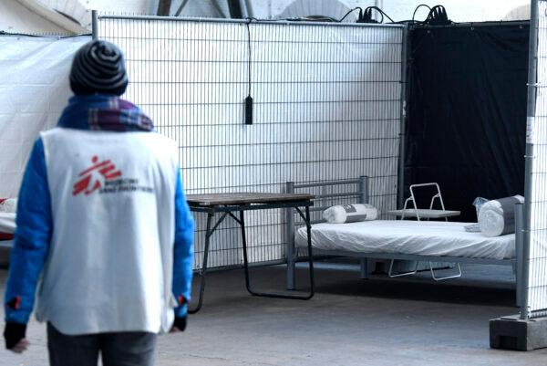 A volunteer walks at a temporary Doctors Without Borders (MSF) 50 places shelter for homeless people suspected of being infected with the CCP virus, causing the COVID-19 illness, in Brussels, Belgium, on March 30, 2020. (Didier Lebrun/BELGA/AFP/Getty Images)