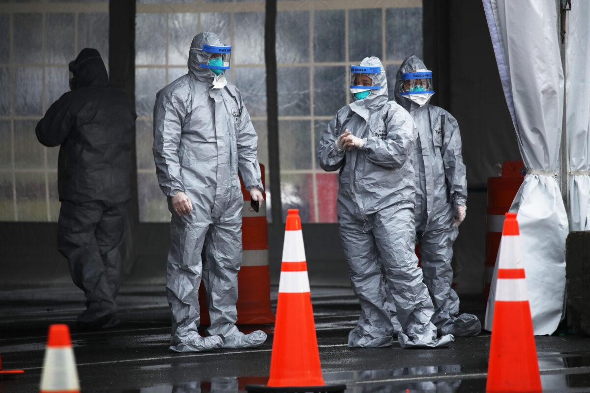 Workers in protective gear operate a drive-through COVID-19 mobile testing center in New Rochelle, New York on March 13, 2020. (Spencer Platt/Getty Images)